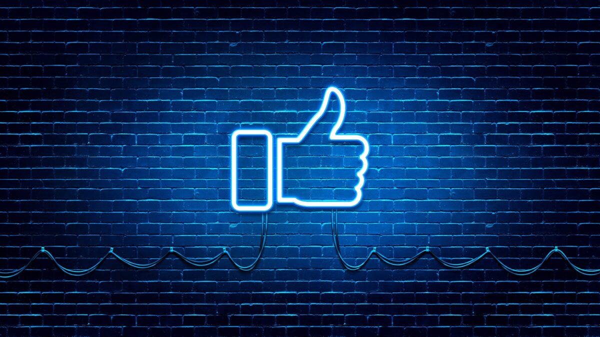 Neon Glowing Like (thumb) Button for Social Media on Brick Wall. Neon Facebook like icon illustration.