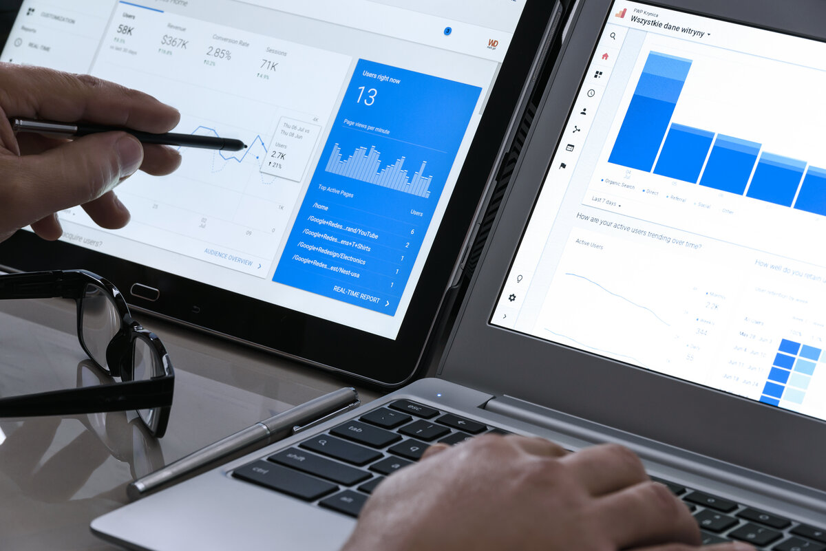 Krynica-Zdroj, Poland – July 11, 2017: Businessman using Google Analytics in the office on the touch screen of his tablet. Google Analytics is the most famous application for web traffic analysis.