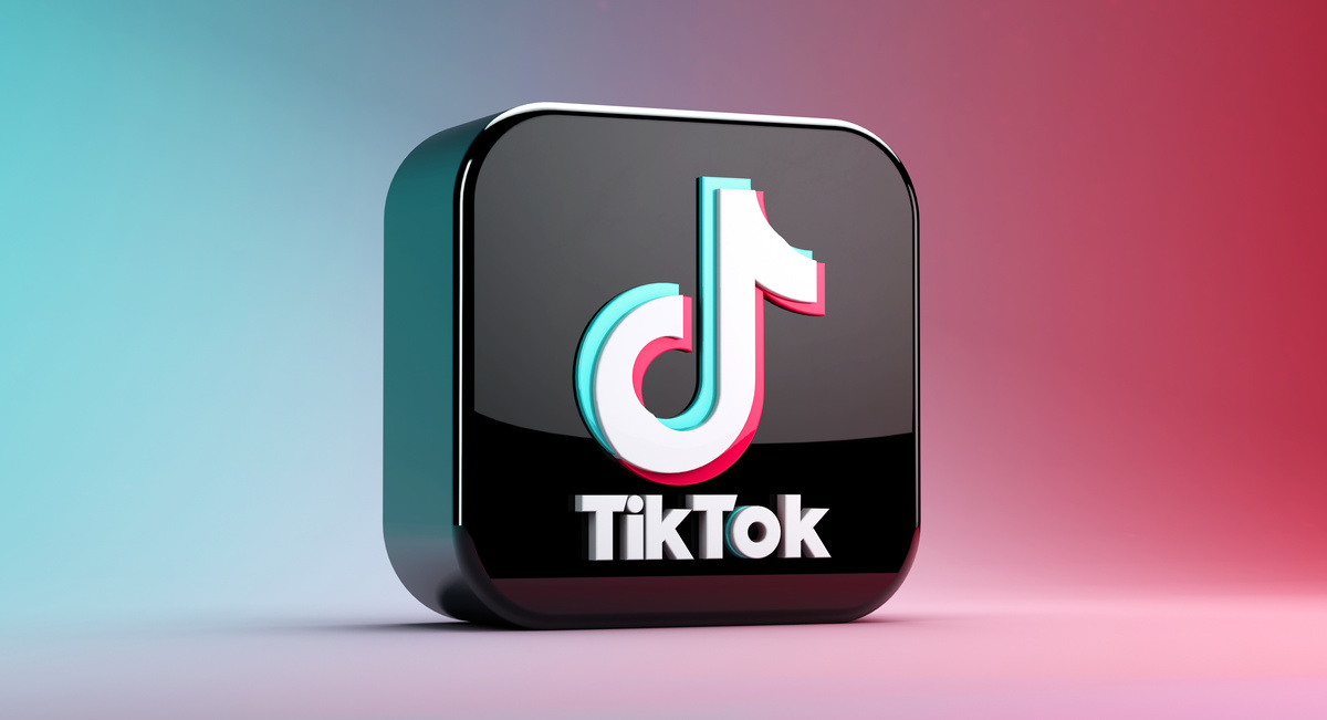 Valencia, Spain – December 2020: 3D rendering of TikTok app icon isolated on a blue and red gradient background. Close-up mockup of Tik Tok application logo. Tiktok is a Social media network for video