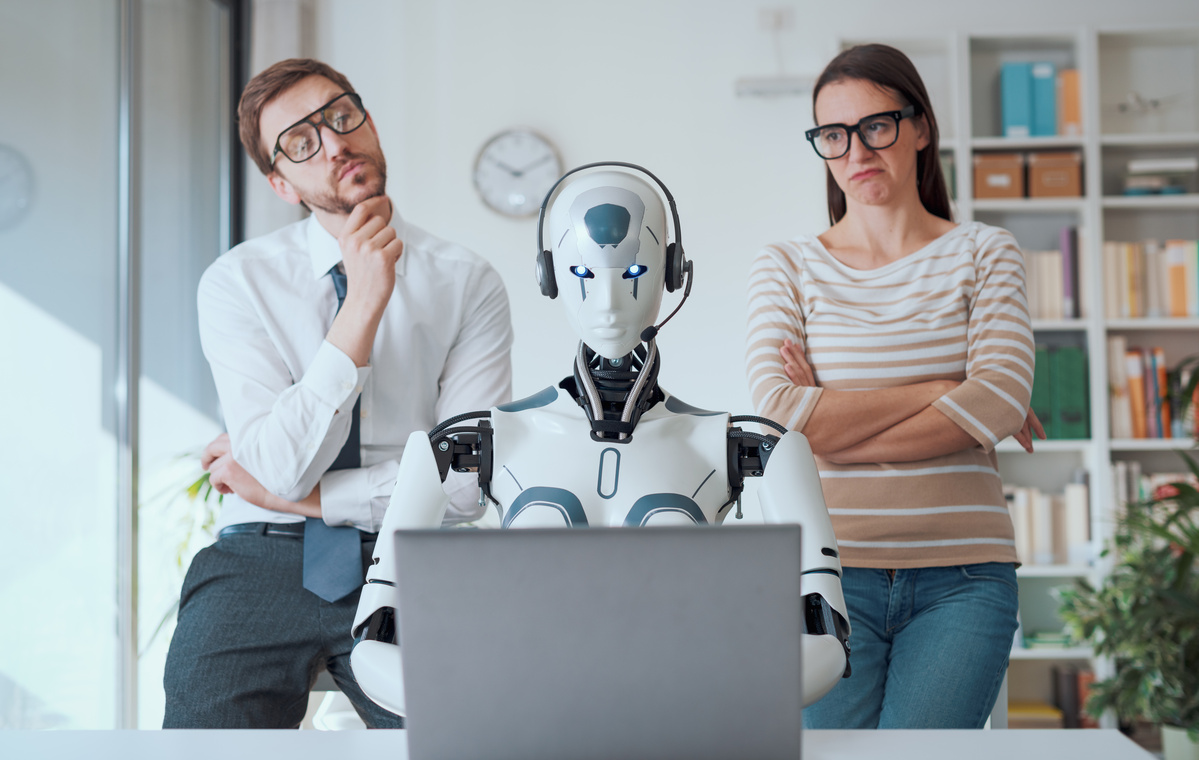 Business people supervising a robot work